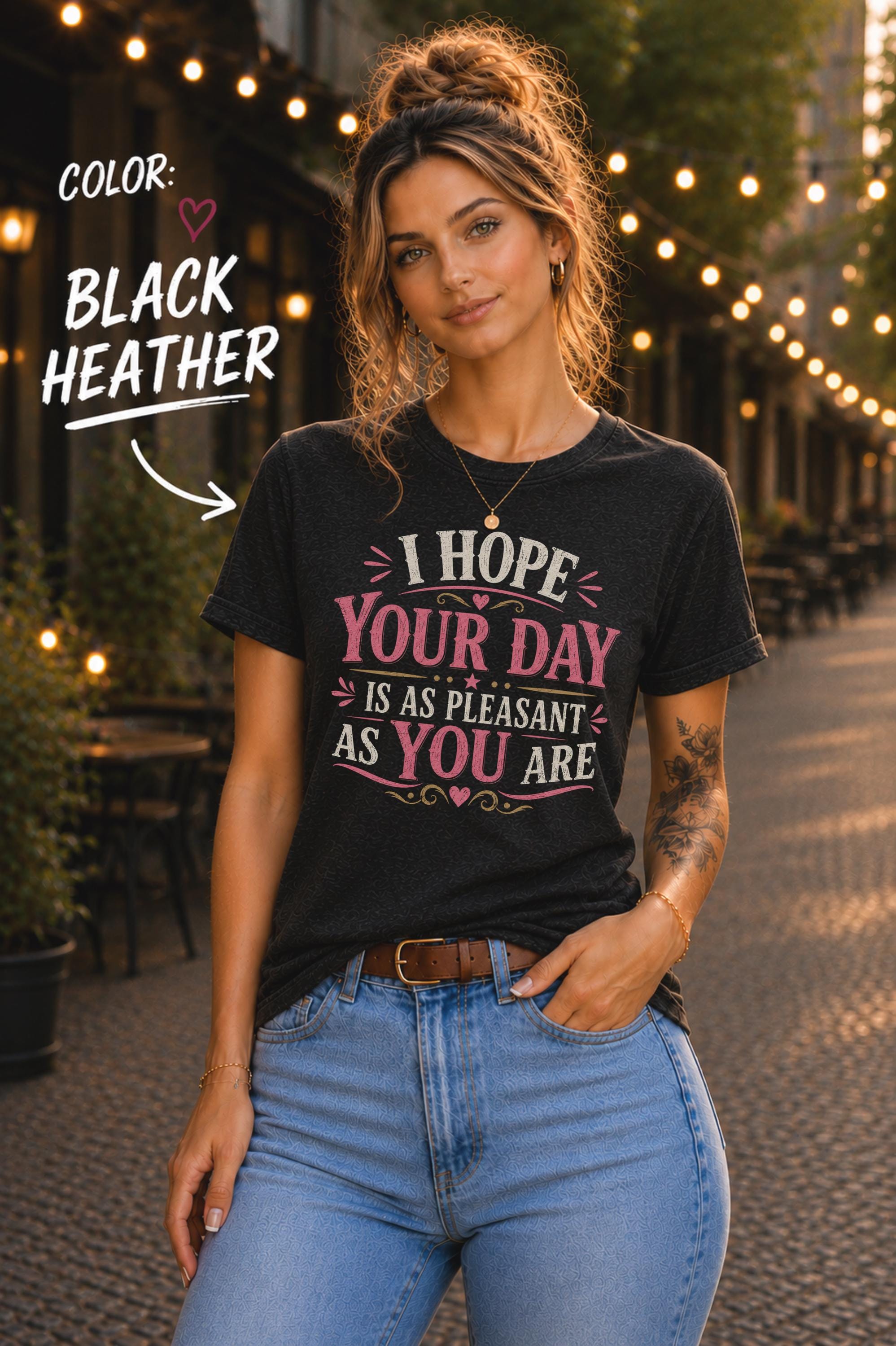 Black Heather Bella+Canvas t-shirt featuring the sarcastic quote "I Hope Your Day Is As Pleasant As You Are" in distressed pink and cream typography on a relaxed unisex fit.