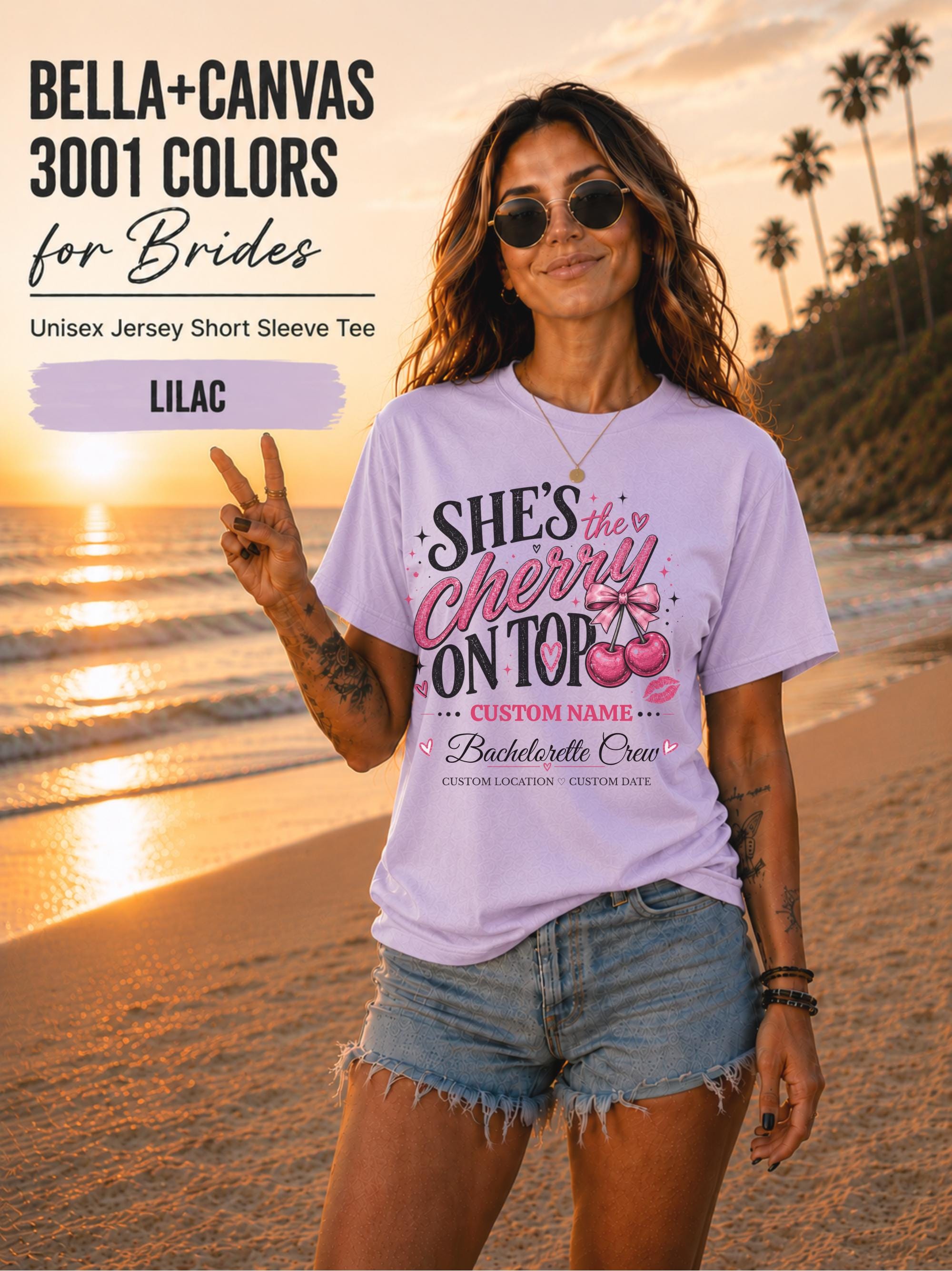 Bella+Canvas 3001 Lilac unisex T-shirt featuring a customizable "She's the Cherry on Top" bachelorette crew design with pink cherries, custom name, location, and wedding date for bridal party celebrations.