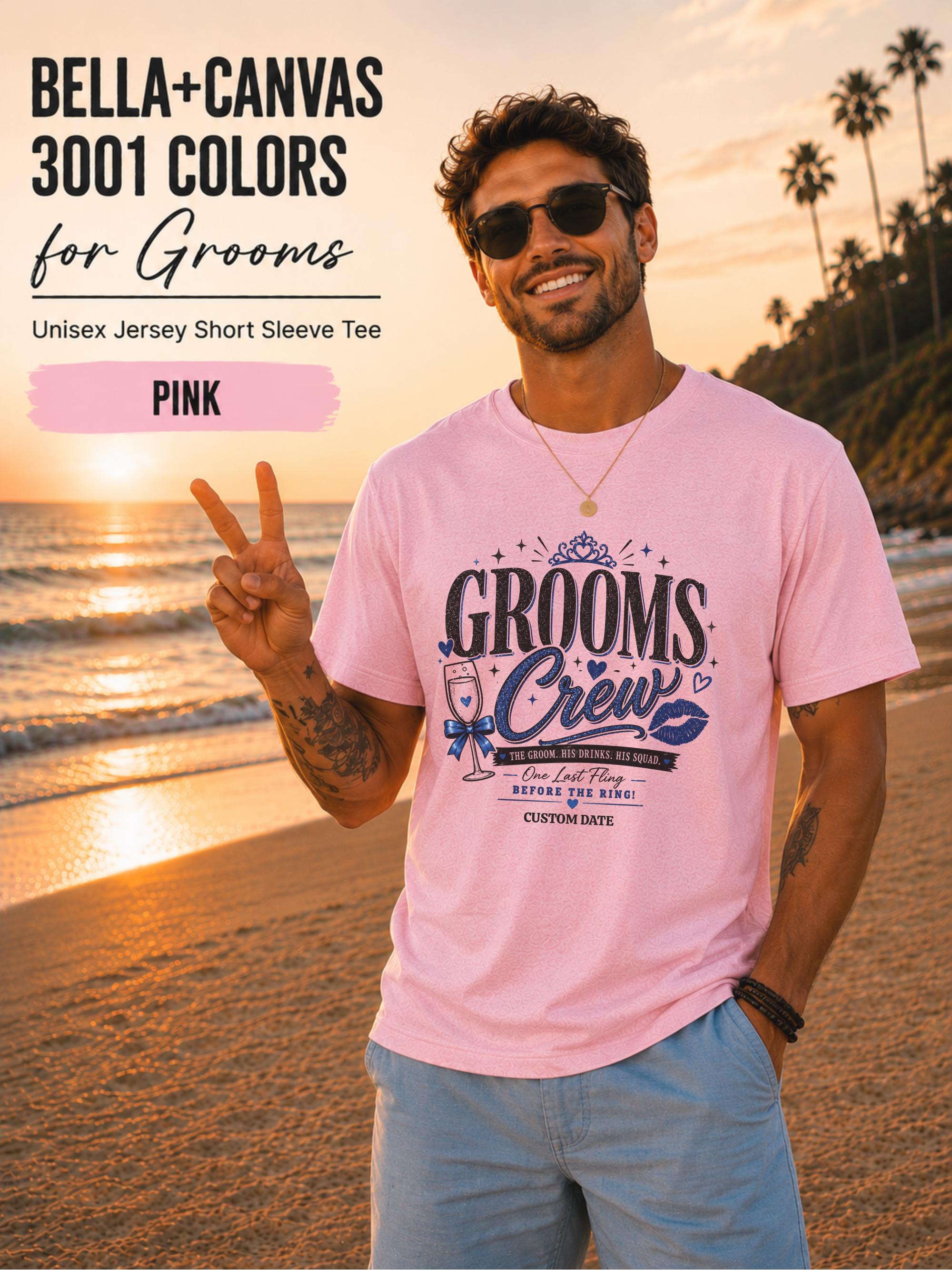 Bella+Canvas 3001 Pink groom crew shirt featuring a blue wedding party design with champagne glass, crown, kiss mark, and customizable wedding date for bachelor party celebrations.