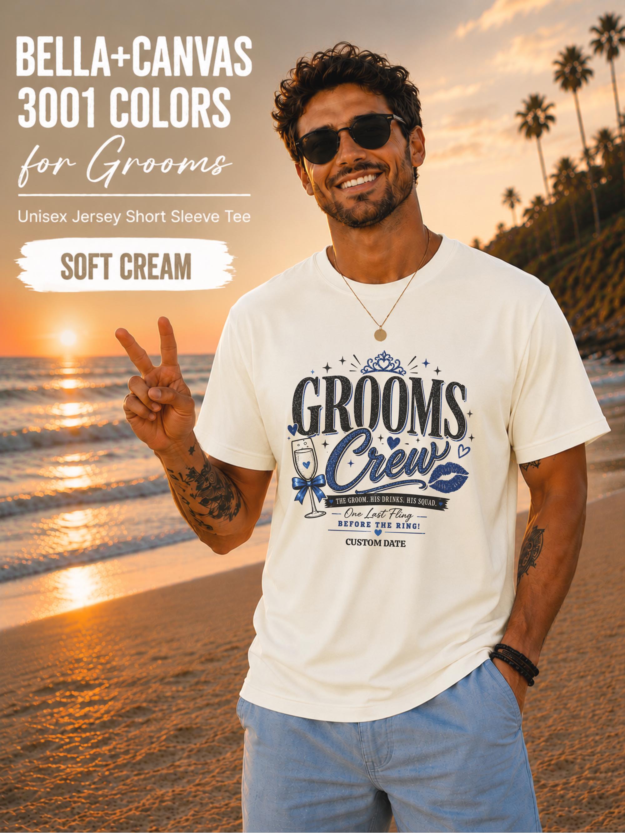 Bella+Canvas 3001 Soft Cream groom crew shirt featuring a blue wedding party design with champagne glass, crown, kiss mark, and customizable wedding date for bachelor party celebrations.