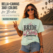 Bella+Canvas 3001 Heather Prism Mint bride crew shirt featuring a pink and black bachelorette design with champagne glass, crown, kiss mark, and customizable wedding date.