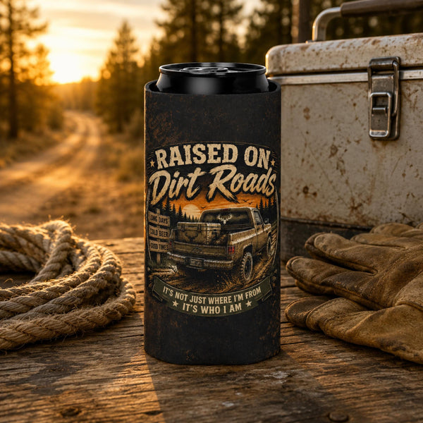 Slim can cooler featuring the "Raised on Dirt Roads" vintage pickup truck design on a rustic tailgate with an old cooler and country sunset backdrop, perfect for beer lovers, camping, and country living.