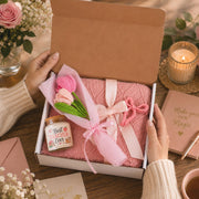 Teacher appreciation gift box featuring a blush pink knit blanket, Best Teacher Ever candle, crochet flower bouquet, and pink bow clip arranged in elegant gift-ready packaging.