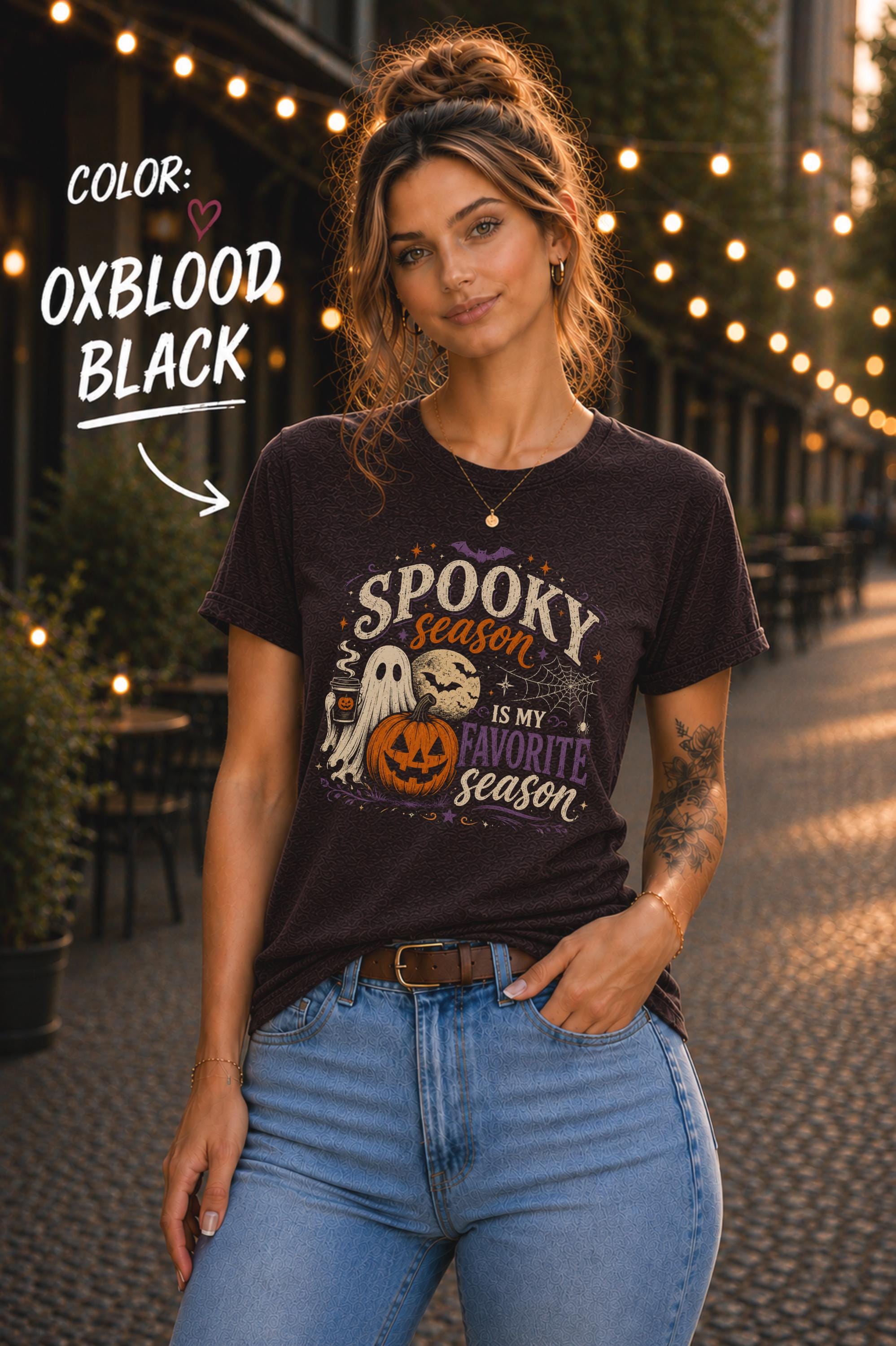 Woman wearing a Bella+Canvas 3001 Oxblood Black unisex T-shirt featuring a vintage Halloween design with a cute ghost, pumpkin, spiderweb, full moon, and the phrase "Spooky Season Is My Favorite Season."