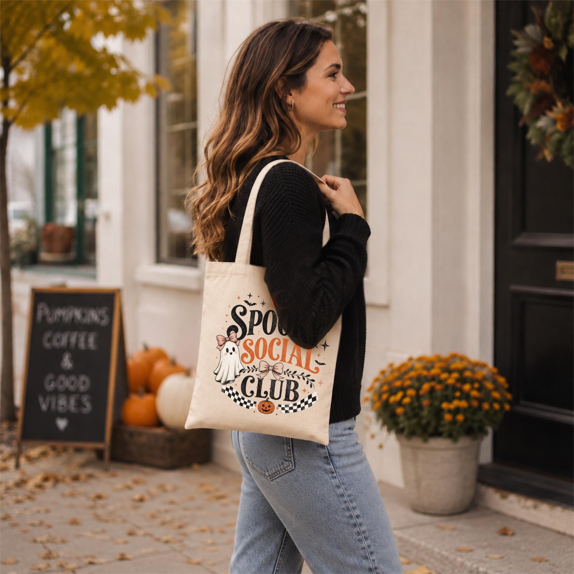 Natural canvas tote bag featuring a vintage Spooky Social Club design with a cute ghost, bows, bats, moon, pumpkin, and retro Halloween typography, perfect for everyday fall use and Halloween shopping.