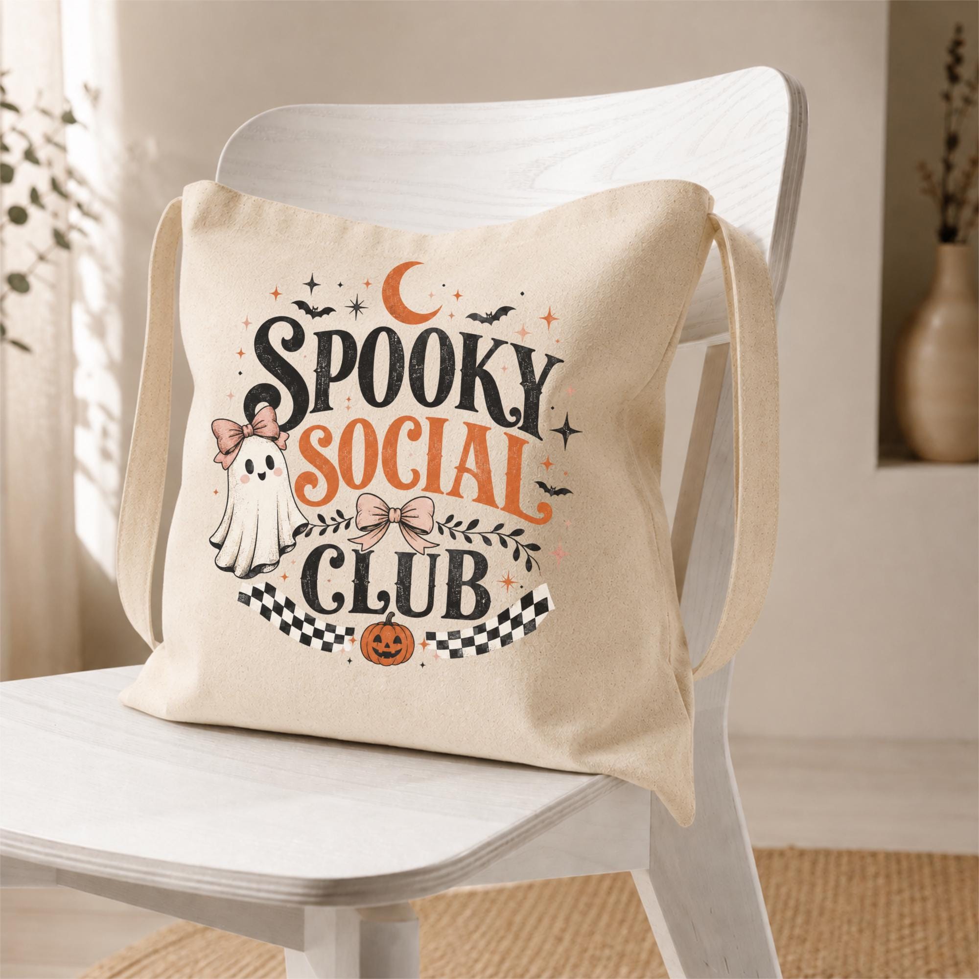 Natural canvas tote bag featuring a vintage Spooky Social Club design with a cute ghost, bows, bats, moon, pumpkin, and retro Halloween typography, perfect for everyday fall use and Halloween shopping.