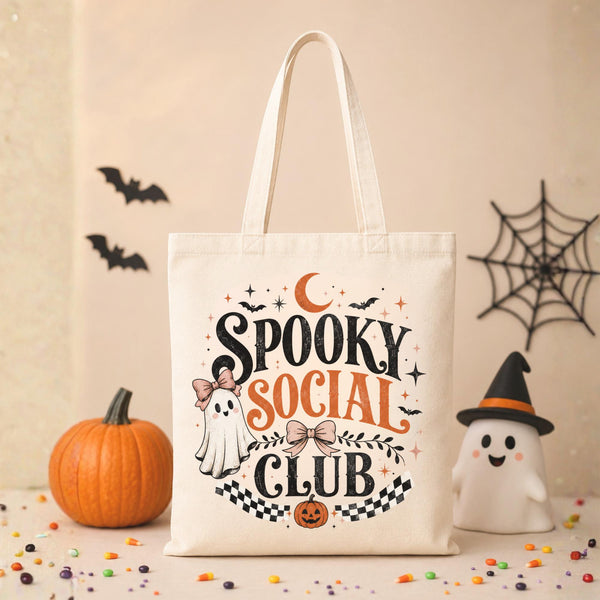 Natural canvas tote bag featuring a vintage Spooky Social Club design with a cute ghost, bows, bats, moon, pumpkin, and retro Halloween typography, perfect for everyday fall use and Halloween shopping.
