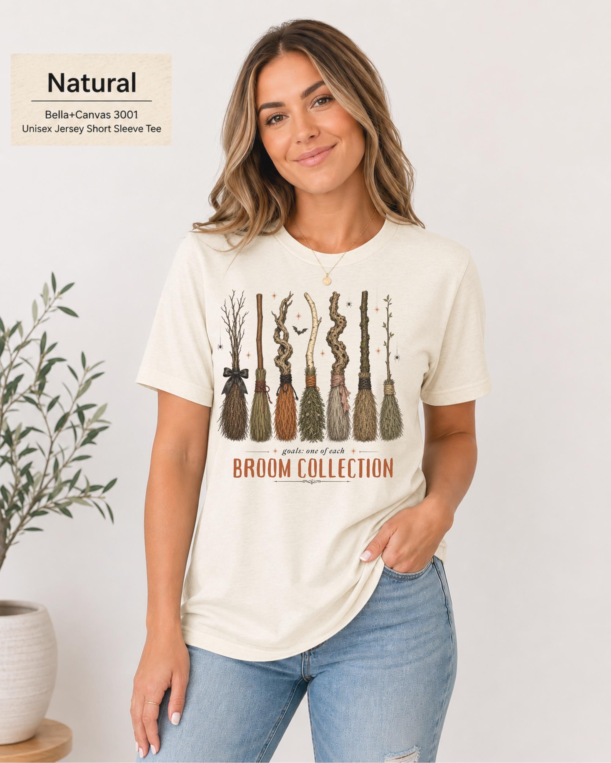 Bella+Canvas 3001 Natural unisex t-shirt featuring a vintage Broom Collection graphic with illustrated witch brooms, earthy autumn colors, and cozy Halloween-inspired artwork.