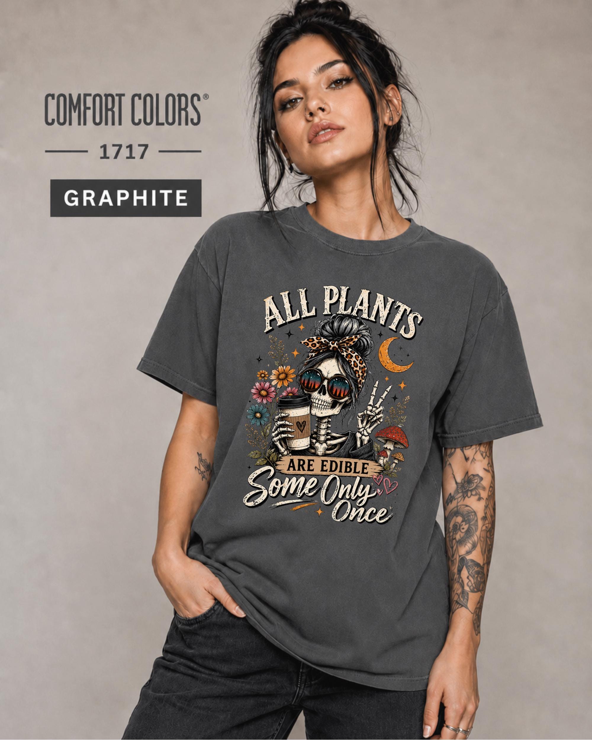 Comfort Colors 1717 Graphite unisex t-shirt featuring a vintage skeleton holding coffee with the funny quote "All Plants Are Edible, Some Only Once," surrounded by flowers, mushrooms, and spooky botanical artwork.