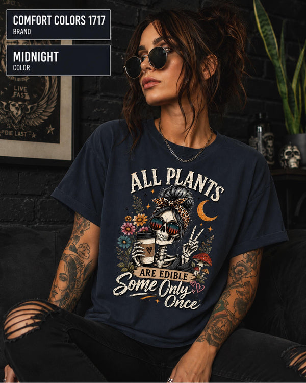 Comfort Colors 1717 Midnight unisex t-shirt featuring a vintage skeleton holding coffee with the funny quote "All Plants Are Edible, Some Only Once," surrounded by flowers, mushrooms, and spooky botanical artwork.