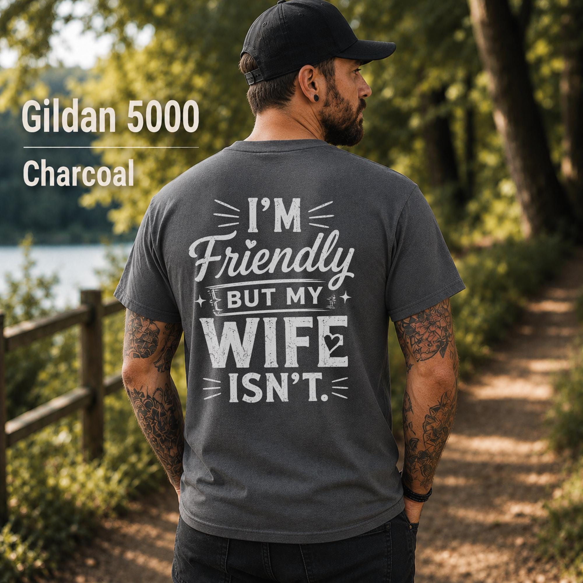 Funny husband t-shirt with "I'm Friendly But My Wife Isn't" back print on a charcoal Gildan 5000 unisex tee, humorous men's graphic shirt for husbands, dads, and Father's Day gifts.