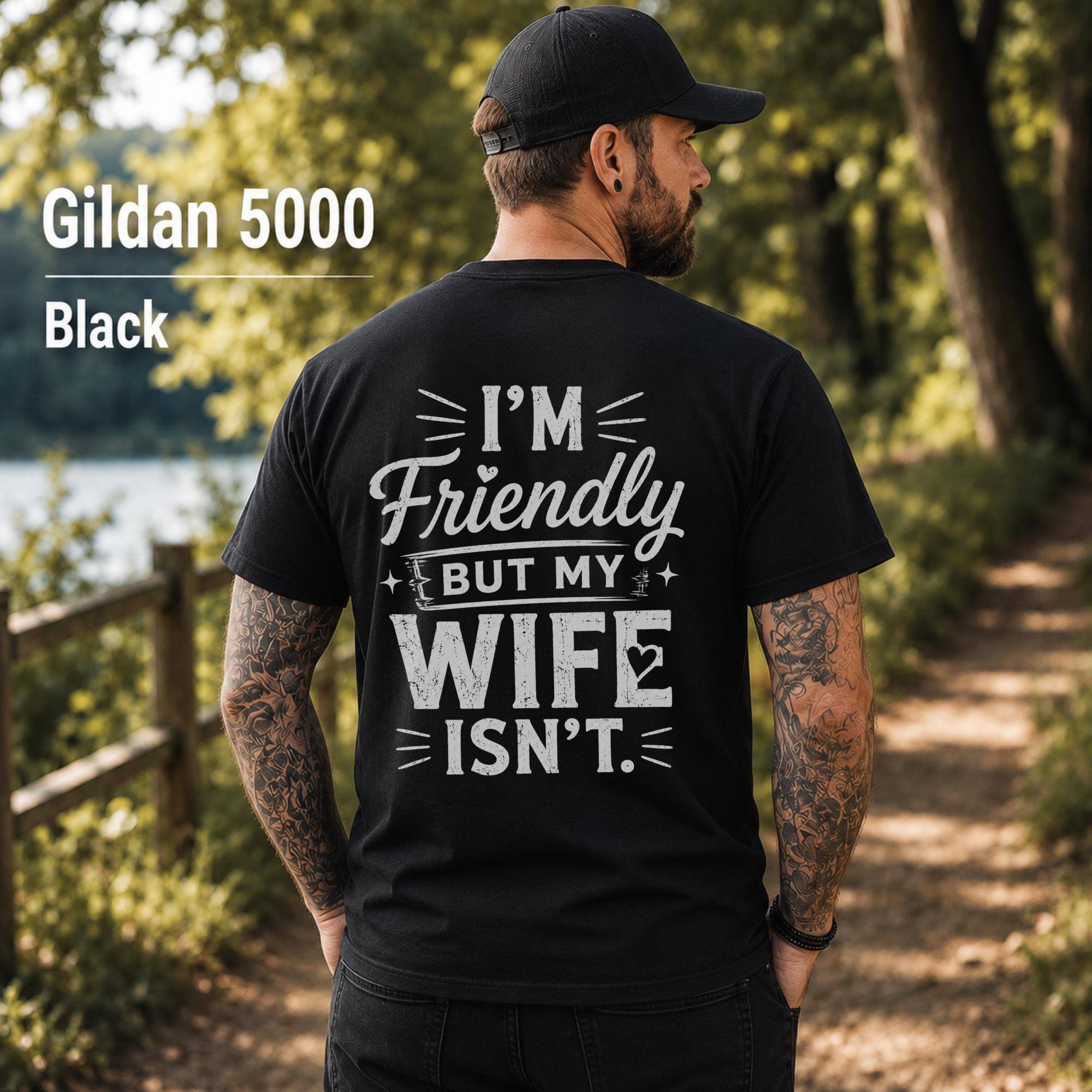 Funny husband t-shirt with "I'm Friendly But My Wife Isn't" back print on a black Gildan 5000 unisex tee, humorous men's graphic shirt for husbands, dads, and Father's Day gifts.