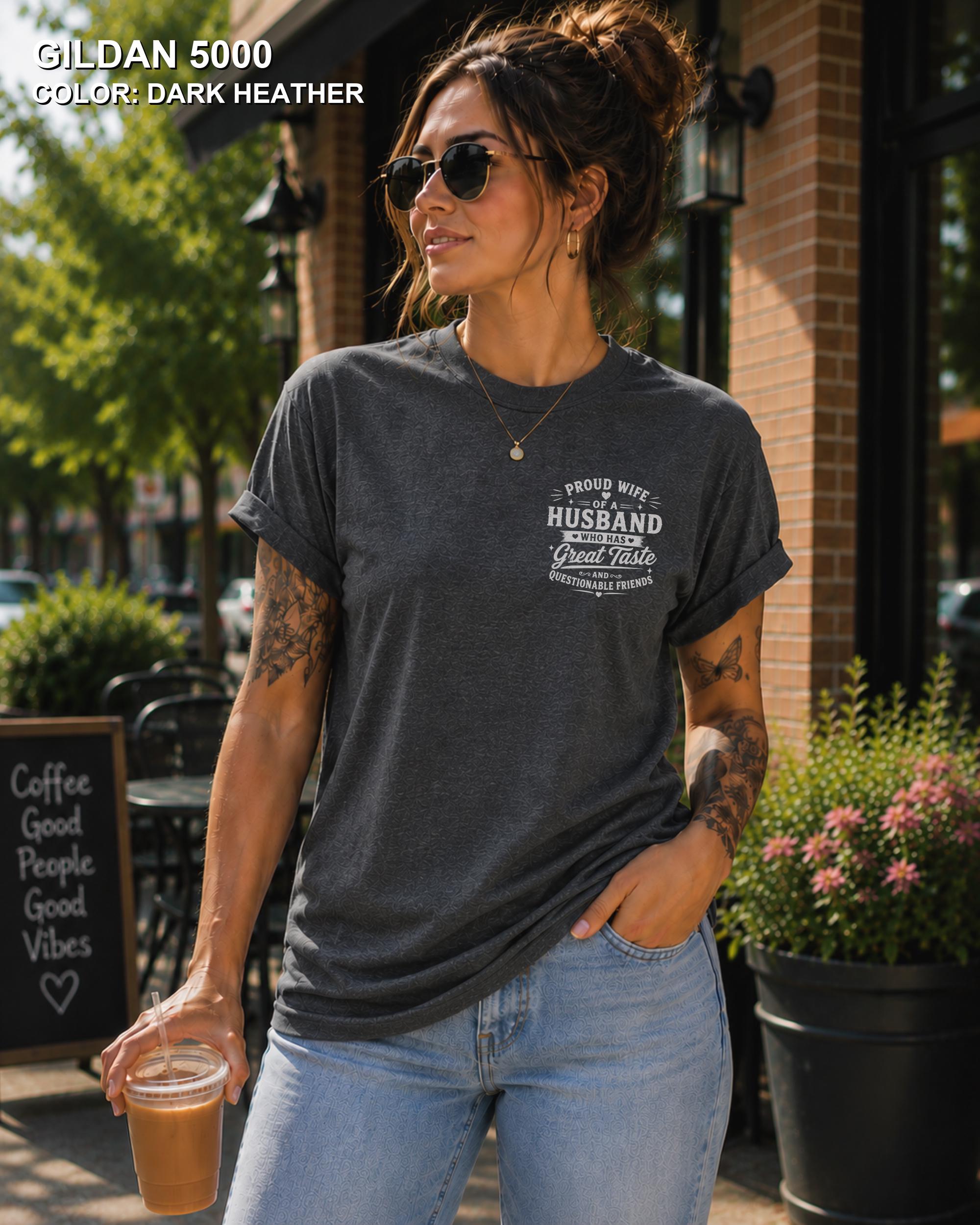 Dark Heather Gildan 5000 unisex t-shirt with a small left chest graphic reading "Proud Wife of a Husband Who Has Great Taste and Questionable Friends," funny couple apparel.