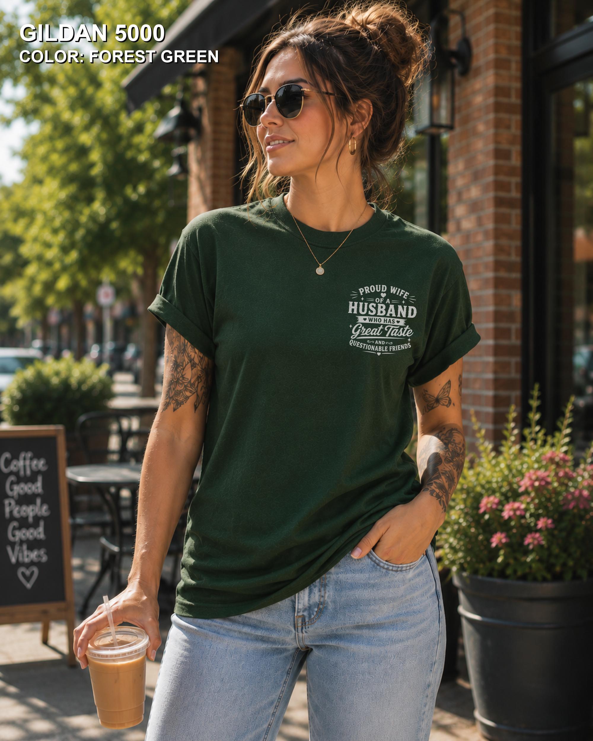 Forest Green Gildan 5000 unisex t-shirt with a small left chest graphic reading "Proud Wife of a Husband Who Has Great Taste and Questionable Friends," funny couple apparel.