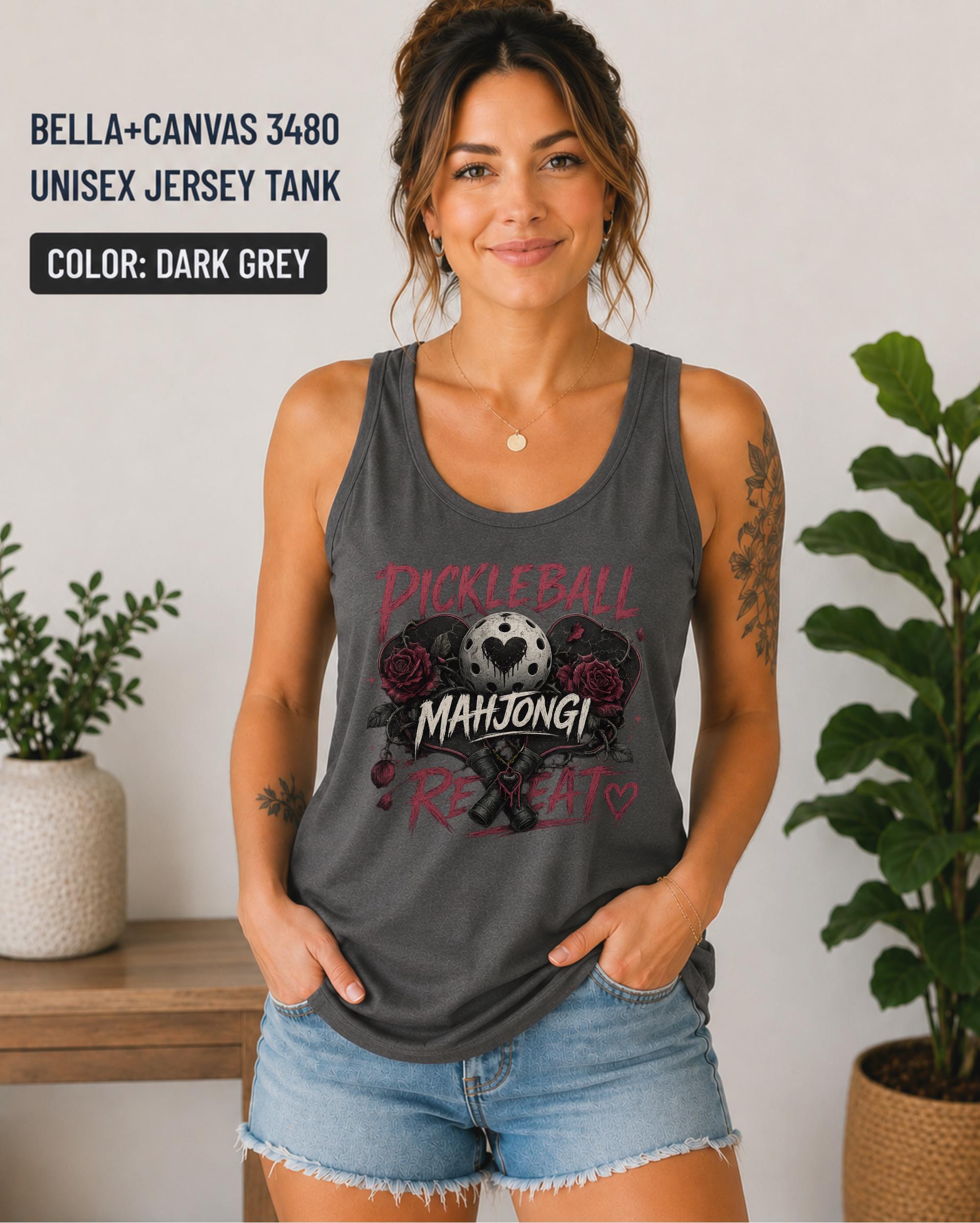 Woman wearing a dark grey Bella+Canvas 3480 jersey tank featuring a gothic "Pickleball Mahjong Repeat" design with burgundy roses, distressed lettering, crossed paddles, and a heart-detail pickleball.
