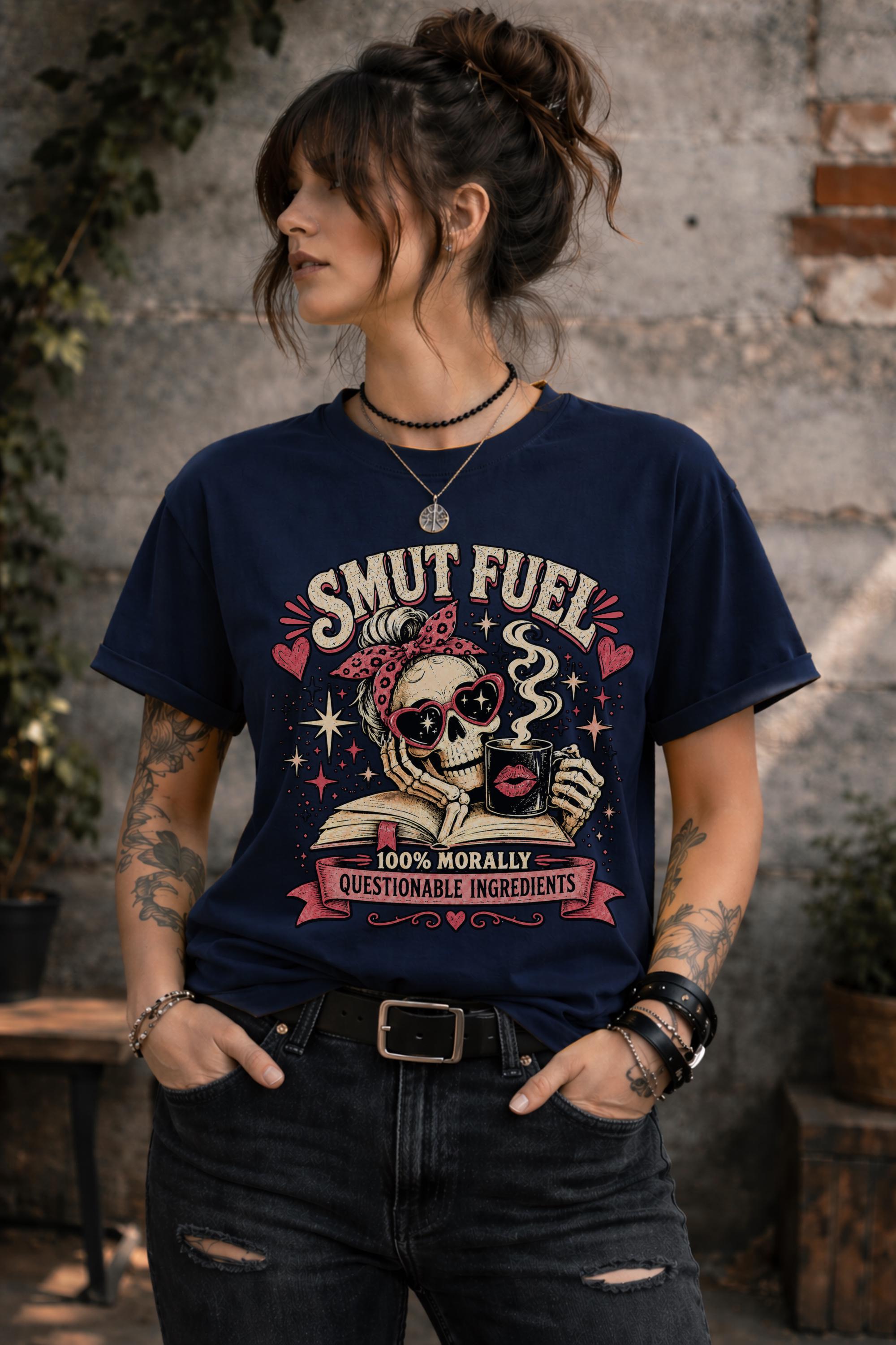 Smut Fuel graphic tee featuring a skeleton reader with a coffee mug and dark romance theme