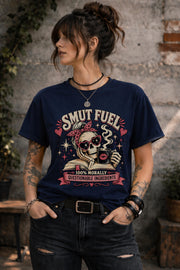 Smut Fuel graphic tee featuring a skeleton reader with a coffee mug and dark romance theme
