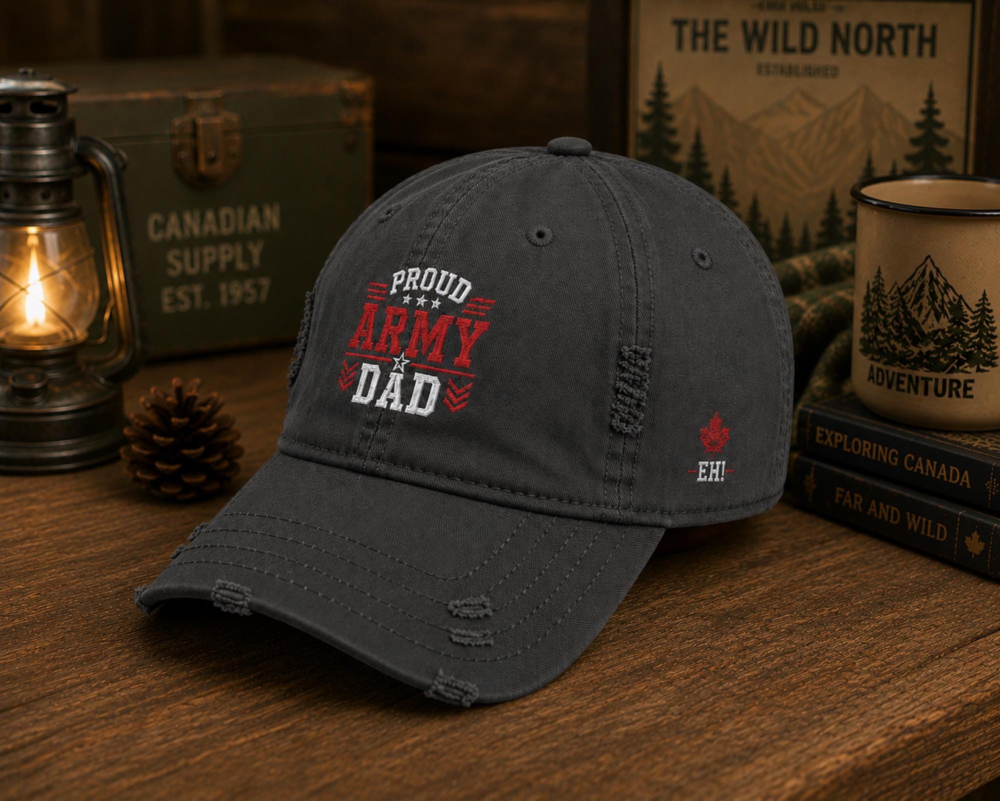 Charcoal distressed embroidered dad hat featuring a bold "Proud Army Dad" design on the front with a red maple leaf and "EH!" embroidery on the side, styled in a rustic outdoor setting with camping accessories.