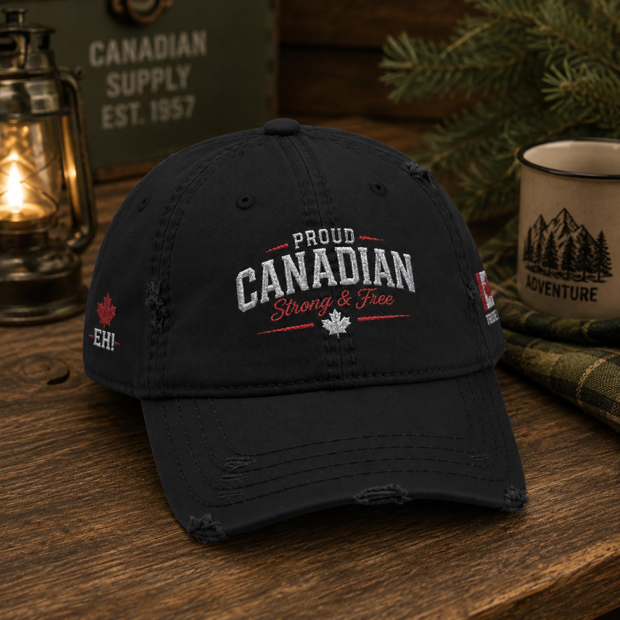 Black distressed embroidered dad hat featuring "Proud Canadian Strong & Free" on the front with maple leaf accents, Canadian flag embroidery on the side, and an EH! maple leaf detail in a rustic outdoor setting.