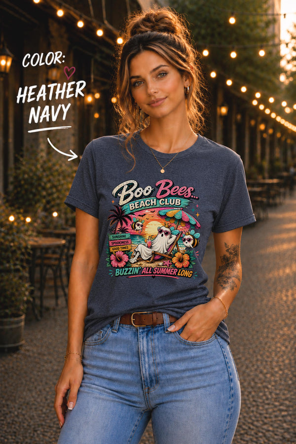 Heather Navy Bella+Canvas t-shirt featuring a Boo Bees Beach Club ghost relaxing on a tropical beach with buzzing bees and sunset artwork.