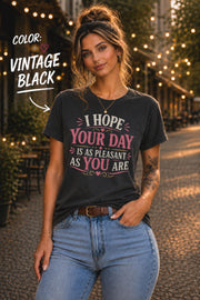Vintage black Bella+Canvas t-shirt featuring the sarcastic quote "I Hope Your Day Is As Pleasant As You Are" in distressed pink and cream typography on a relaxed unisex fit.