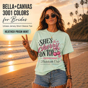 Bella+Canvas 3001 Heather Prism Mint unisex T-shirt featuring a customizable "She's the Cherry on Top" bachelorette crew design with pink cherries, custom name, location, and wedding date for bridal party celebrations.