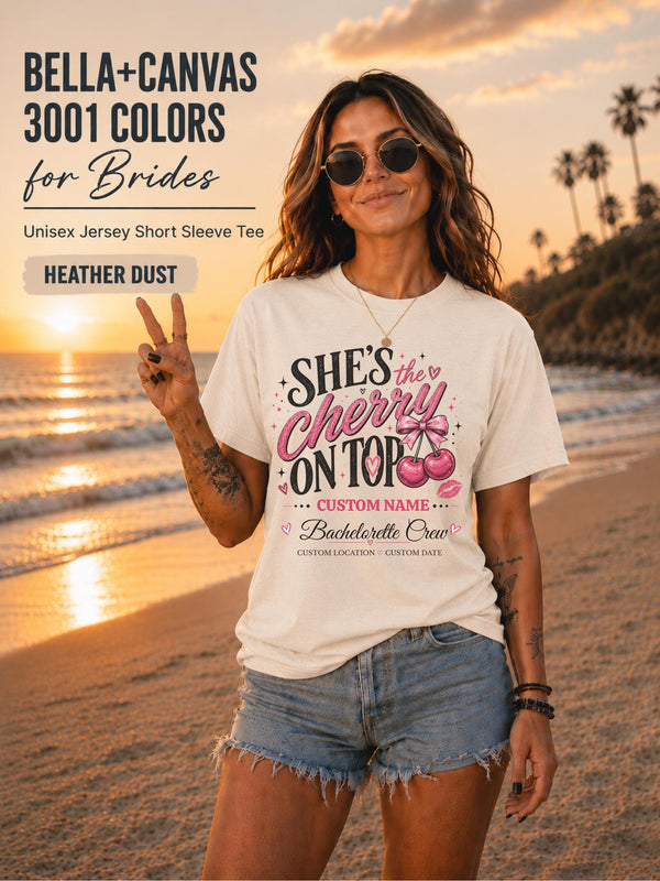 Bella+Canvas 3001  Heather Dust Bella+Canvas 3001 Lilac unisex T-shirt featuring a customizable "She's the Cherry on Top" bachelorette crew design with pink cherries, custom name, location, and wedding date for bridal party celebrations.