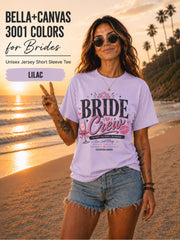 Bella+Canvas 3001 Lilac bride crew shirt featuring a pink and black bachelorette design with champagne glass, crown, kiss mark, and customizable wedding date.