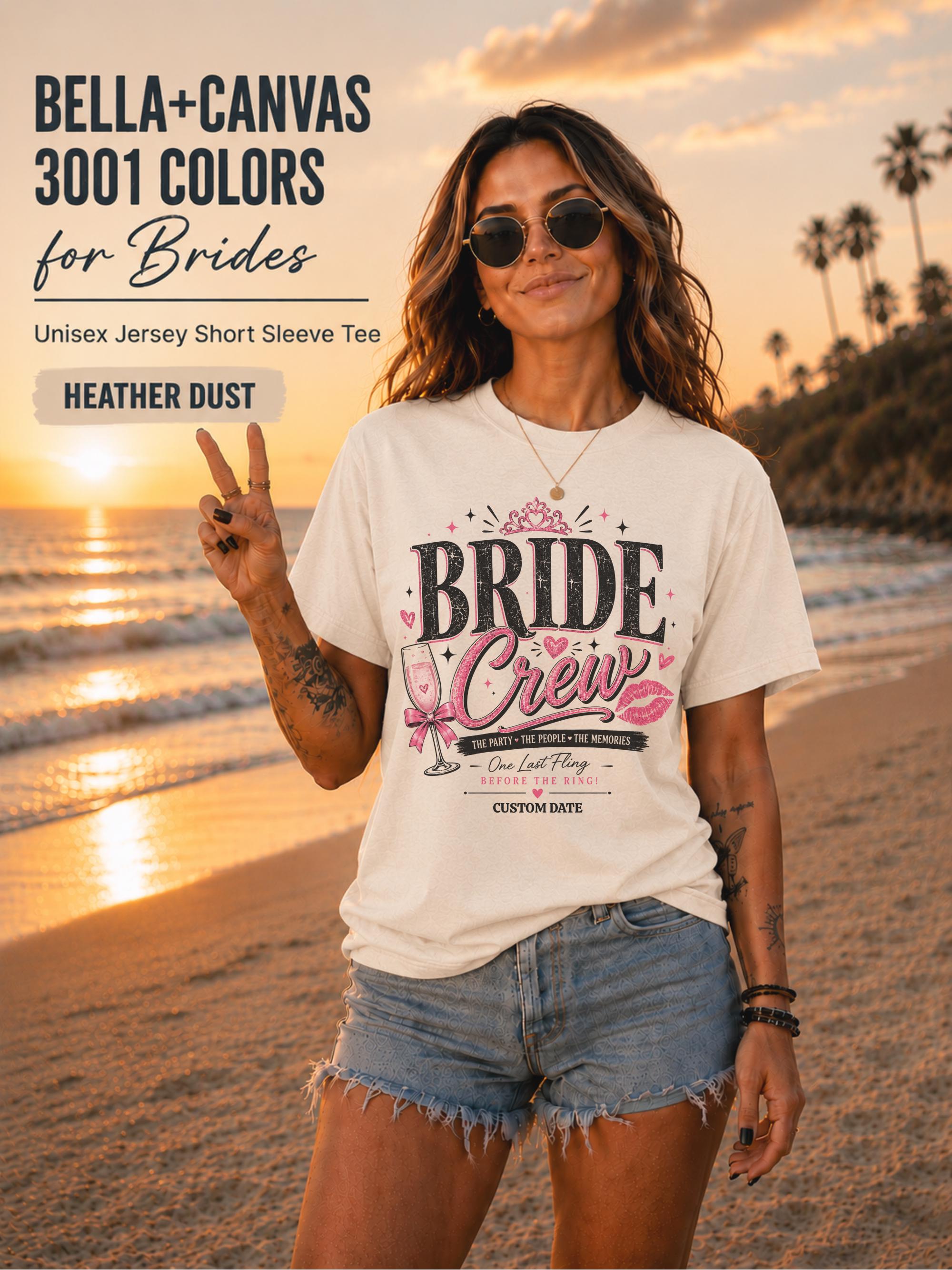 Bella+Canvas 3001 Heather Dust bride crew shirt featuring a pink and black bachelorette design with champagne glass, crown, kiss mark, and customizable wedding date.