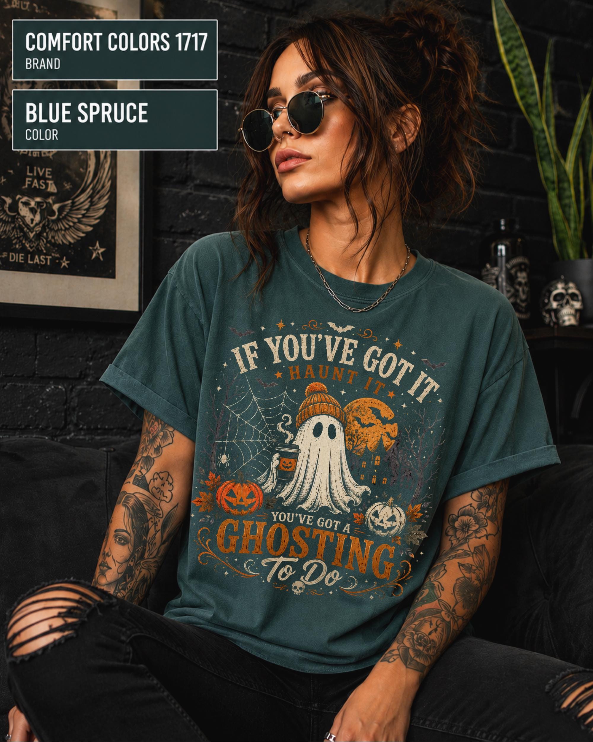 Woman wearing a Comfort Colors 1717 Blue Spruce T-shirt featuring a vintage Halloween ghost design with pumpkins, spiderwebs, haunted house, moon, bats, and the funny quote "If You've Got It Haunt It... You've Got a Ghosting To Do."