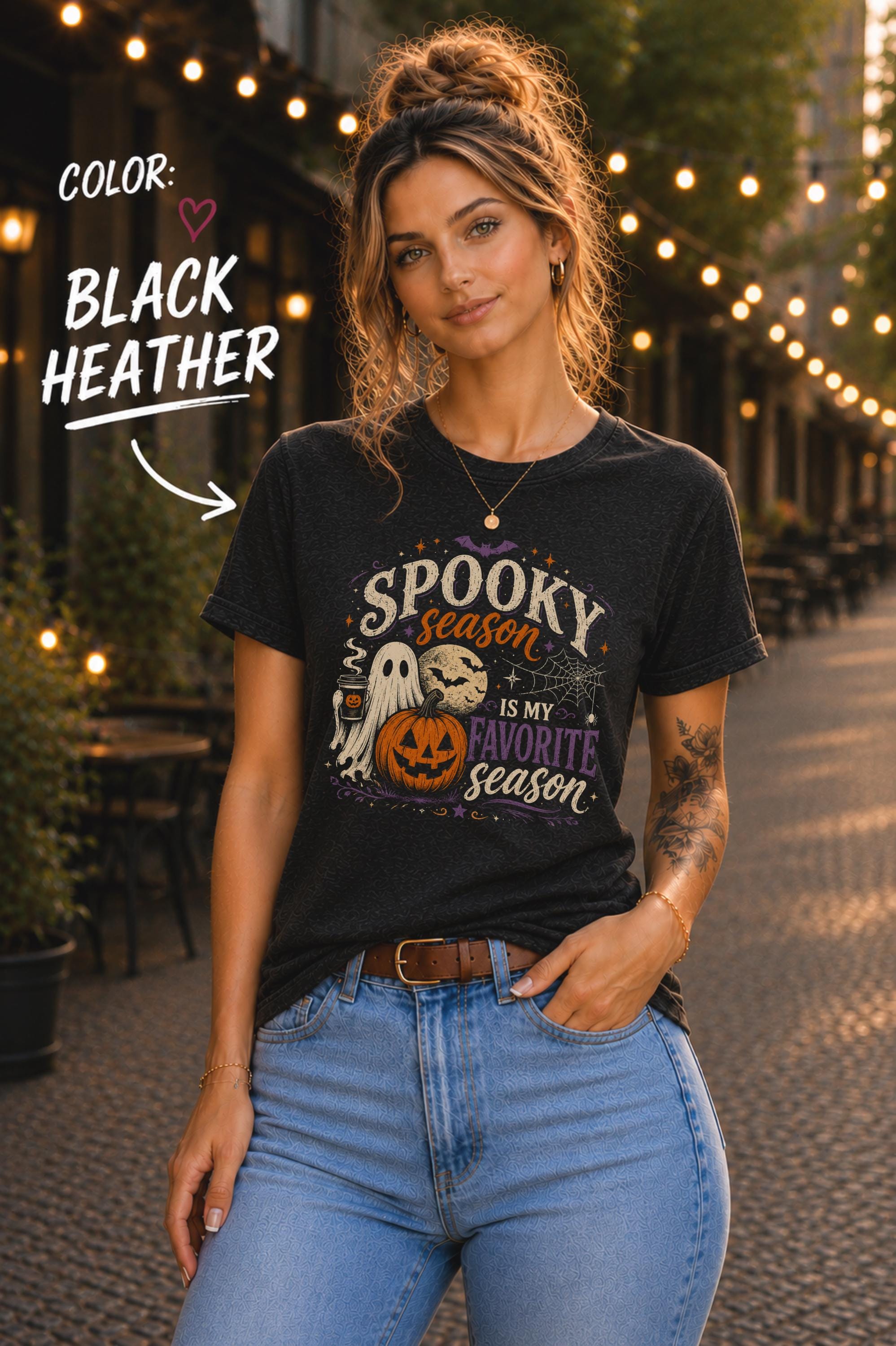 Woman wearing a Bella+Canvas 3001 Black Heather unisex T-shirt featuring a vintage Halloween design with a cute ghost, pumpkin, spiderweb, full moon, and the phrase "Spooky Season Is My Favorite Season."