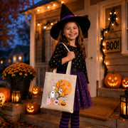 Tan tote bag with a Halloween design featuring a ghost, a pumpkin, and bats in front of a full moon. The text "BOO!" is printed on the bag.