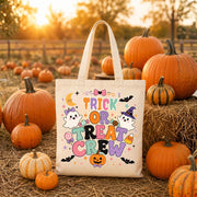 Kids Halloween Trick or Treat tote bag size chart featuring black and natural heavyweight cotton canvas tote bags with colorful ghost, pumpkin, bat, and candy design, product dimensions, features, and care instructions.