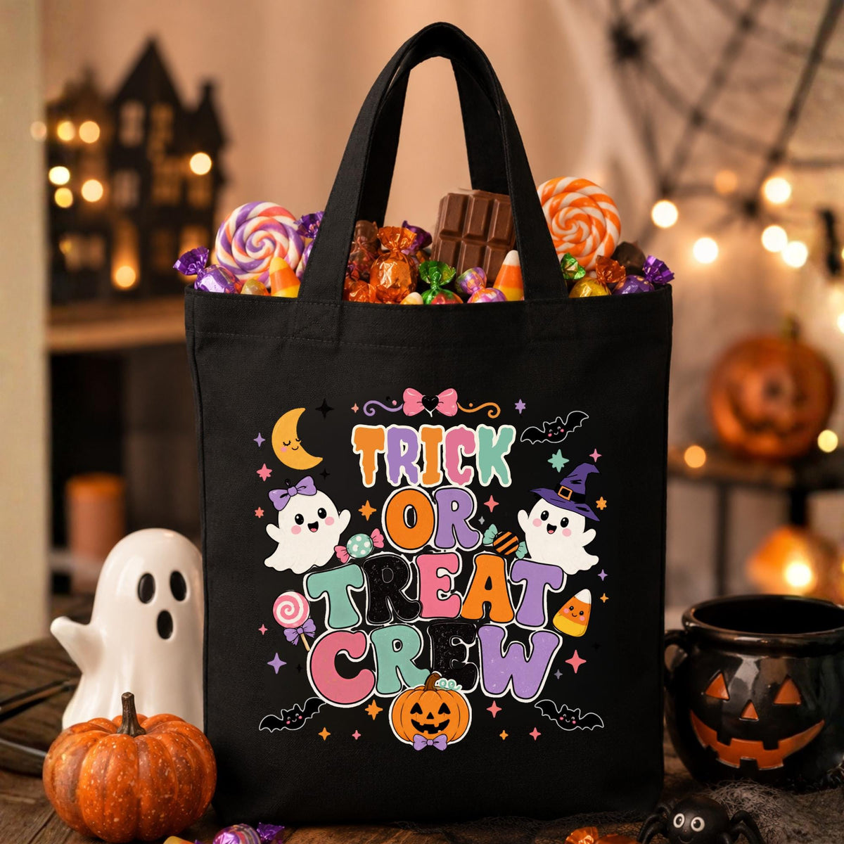 Black and natural canvas Halloween tote bags featuring the colorful "Trick or Treat Crew" design with cute ghosts, pumpkins, candy, bats, and stars for kids' trick-or-treating.