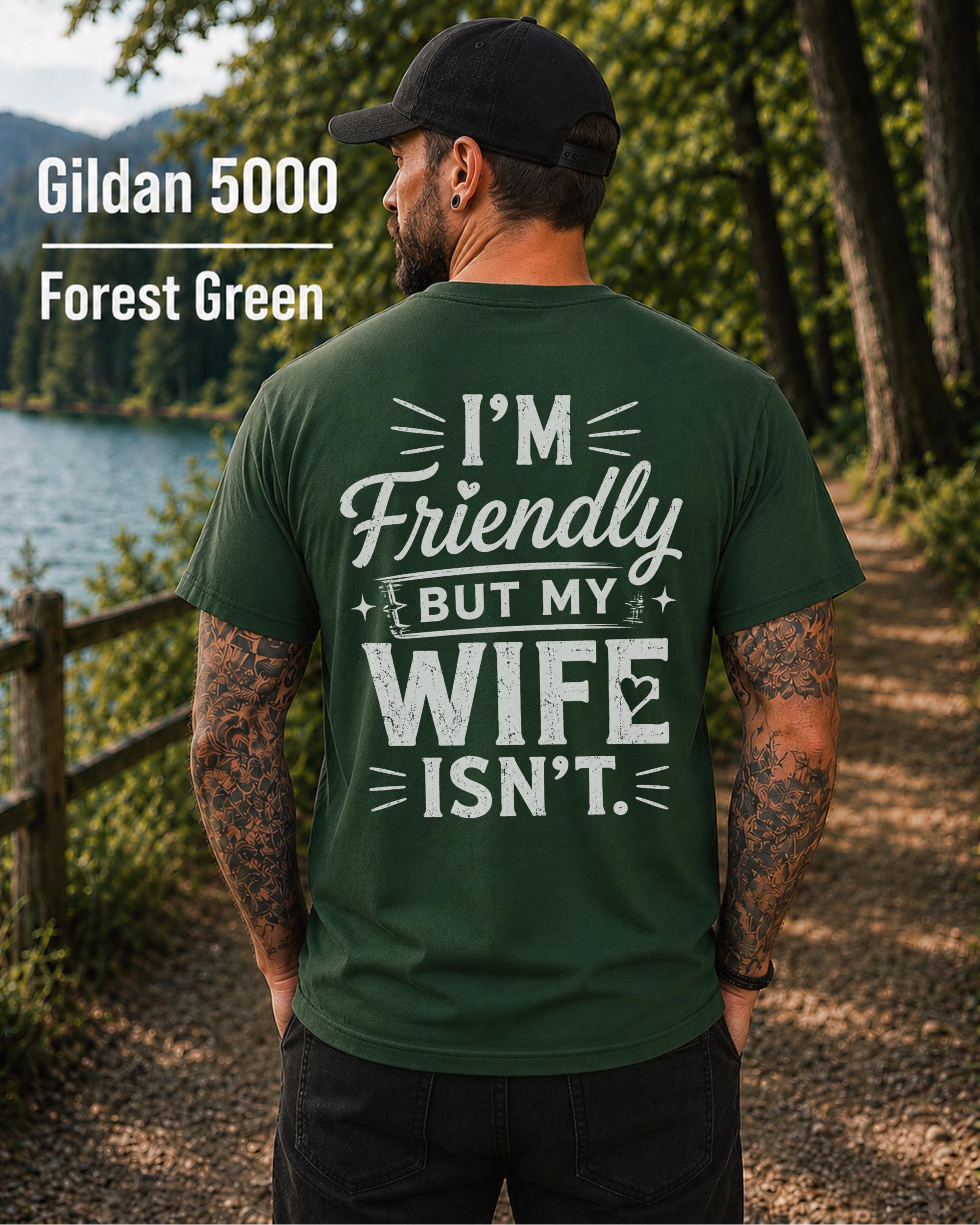 Funny husband t-shirt with "I'm Friendly But My Wife Isn't" back print on a forest green Gildan 5000 unisex tee, humorous men's graphic shirt for husbands, dads, and Father's Day gifts.