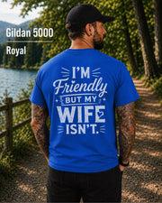 Funny husband t-shirt with "I'm Friendly But My Wife Isn't" back print on a royal Gildan 5000 unisex tee, humorous men's graphic shirt for husbands, dads, and Father's Day gifts.