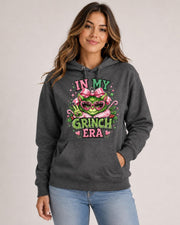 Front view of charcoal heather hoodie with a large pink and green holiday ornament design and festive lettering.