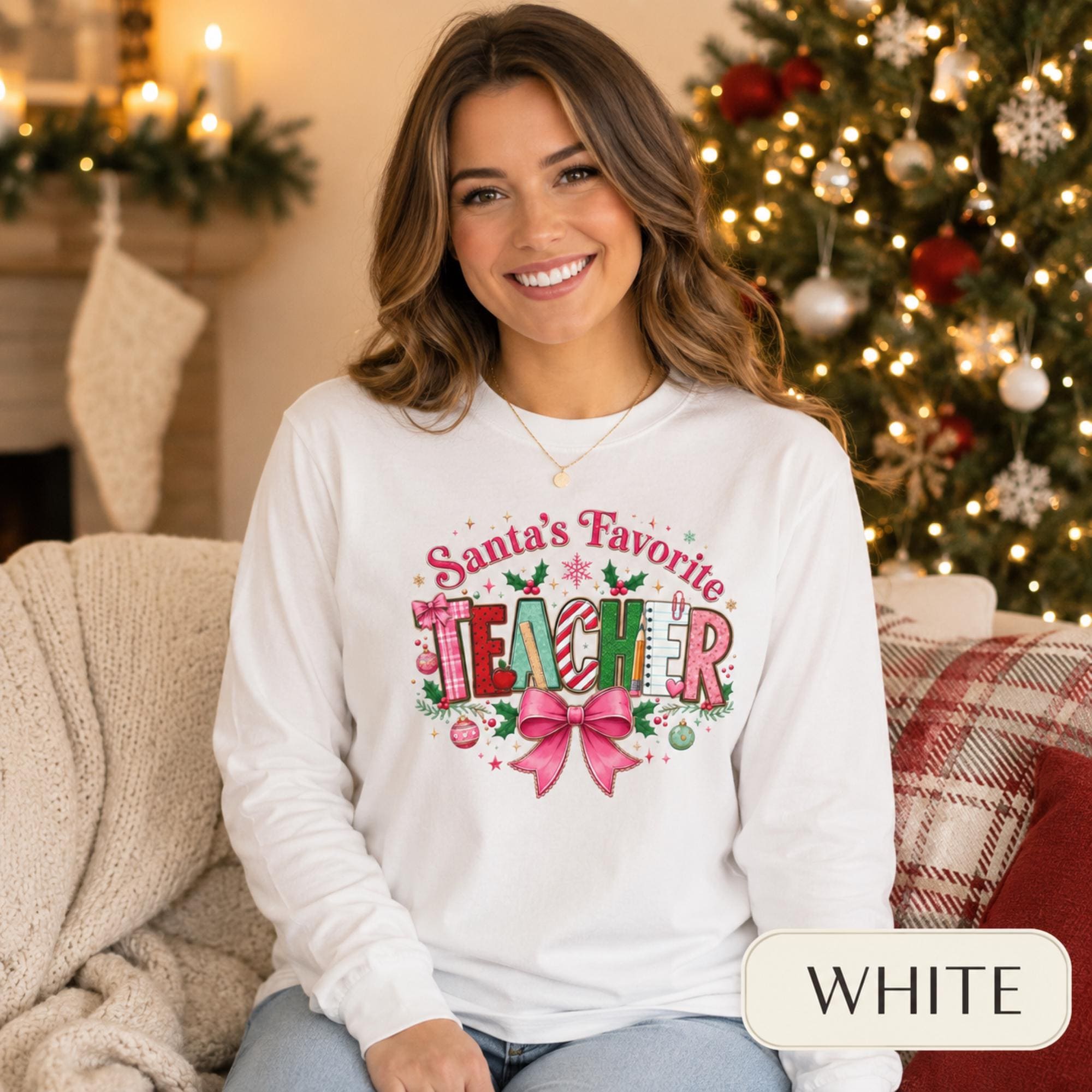 Comfort Colors 6014 long sleeve shirt featuring a colorful Santa’s Favorite Teacher Christmas design with festive lettering, holly, ornaments, school supplies, and a large pink bow.