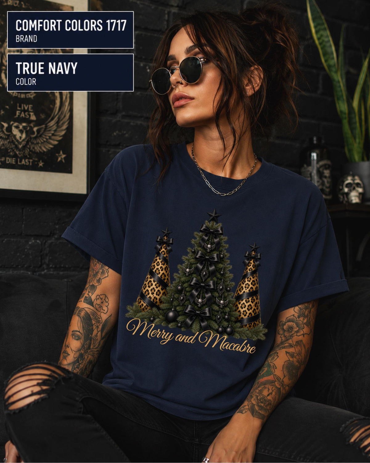 Comfort Colors 1717 True Navy t-shirt featuring a Merry and Macabre gothic Christmas tree design with black bows, skull ornaments, and leopard print trees.
