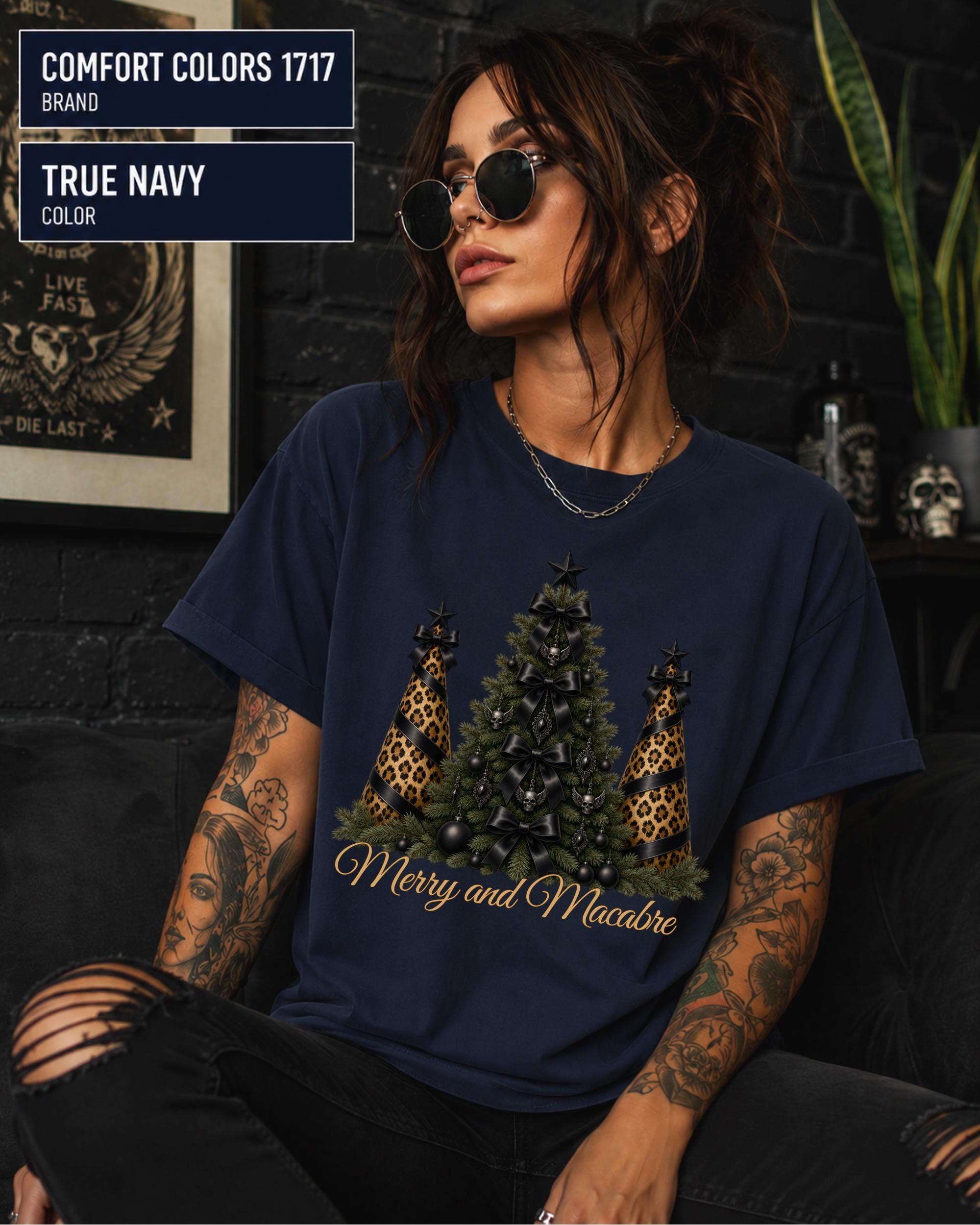 Comfort Colors 1717 True Navy t-shirt featuring a Merry and Macabre gothic Christmas tree design with black bows, skull ornaments, and leopard print trees.