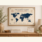 Adventure atlas family travel map wall art in a wooden frame with travel pins, styled in a warm home decor vignette.