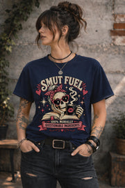 Smut Fuel graphic tee featuring a skeleton reader with a coffee mug and dark romance theme