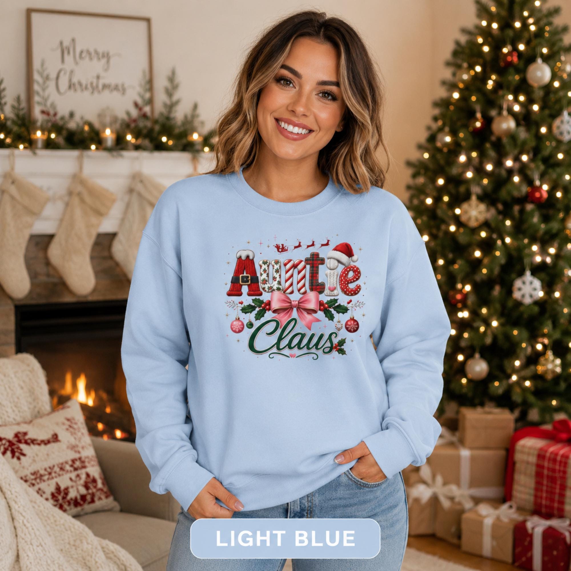 Woman wearing a light blue Auntie Claus Christmas sweatshirt with plaid lettering, pink bow, holly, and ornaments.