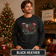 Cozy men’s Christmas sweatshirt styled in a festive living room with a decorated tree, fireplace, and wrapped gifts.