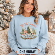 Cozy holiday crewneck sweatshirt featuring festive Christmas trees, gifts, bows, and vintage Christmas typography.