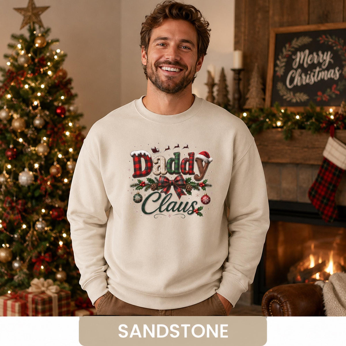Man wearing a sandstone Daddy Claus Christmas sweatshirt with plaid lettering, festive bow, holly, and ornaments.
