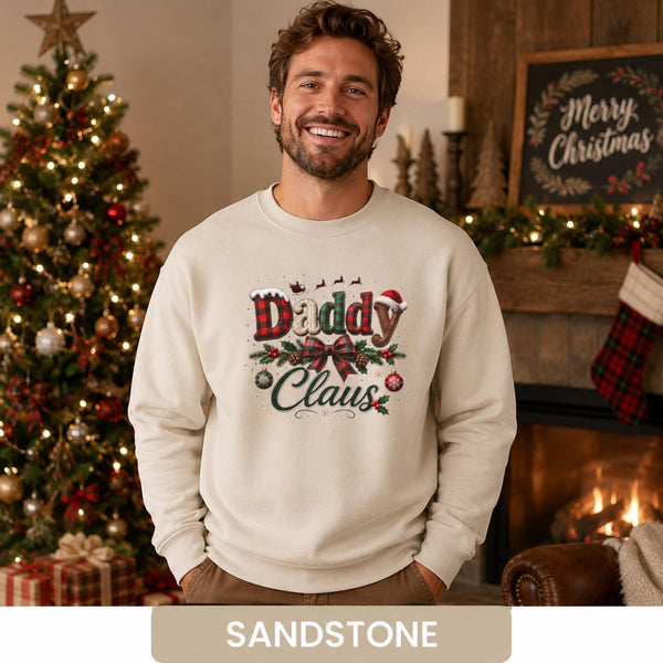 Man wearing a sandstone Daddy Claus Christmas sweatshirt with plaid lettering, festive bow, holly, and ornaments.