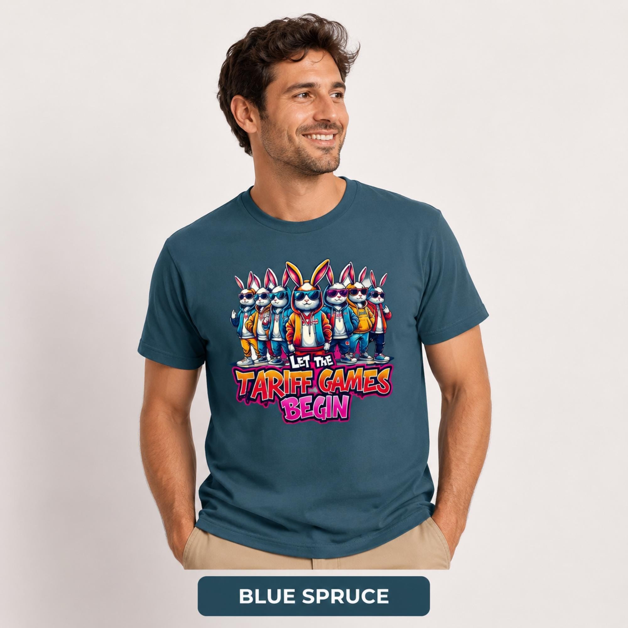 Male model wearing a blue spruce T-shirt featuring stylish cartoon rabbits and bold “Let the Tariff Games Begin” text.