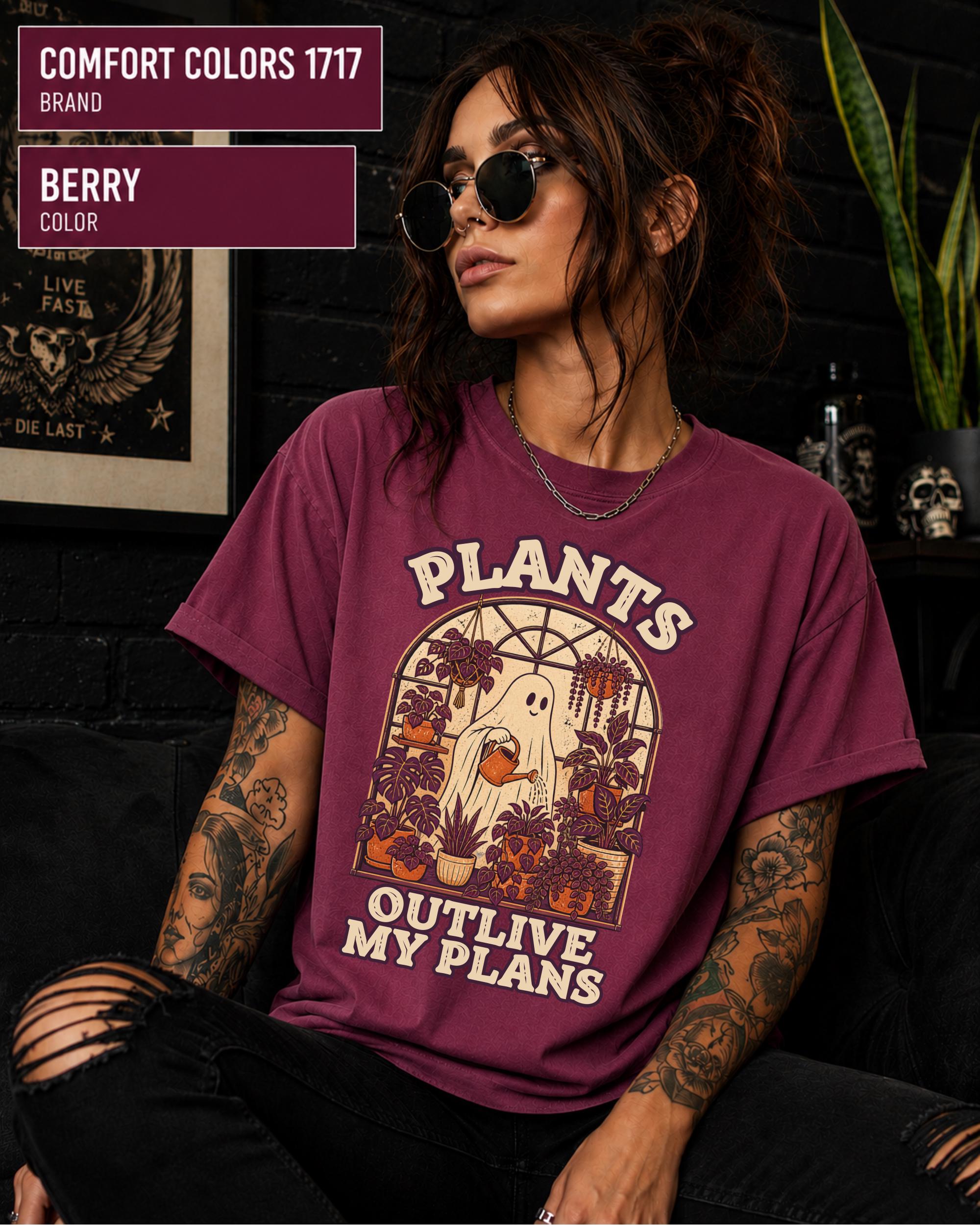 Model wearing Comfort colors tshirt in the color berry featuring a Retro cream and orange ghost watering purple houseplants inside a greenhouse with the words Plants Outlive My Plans.
