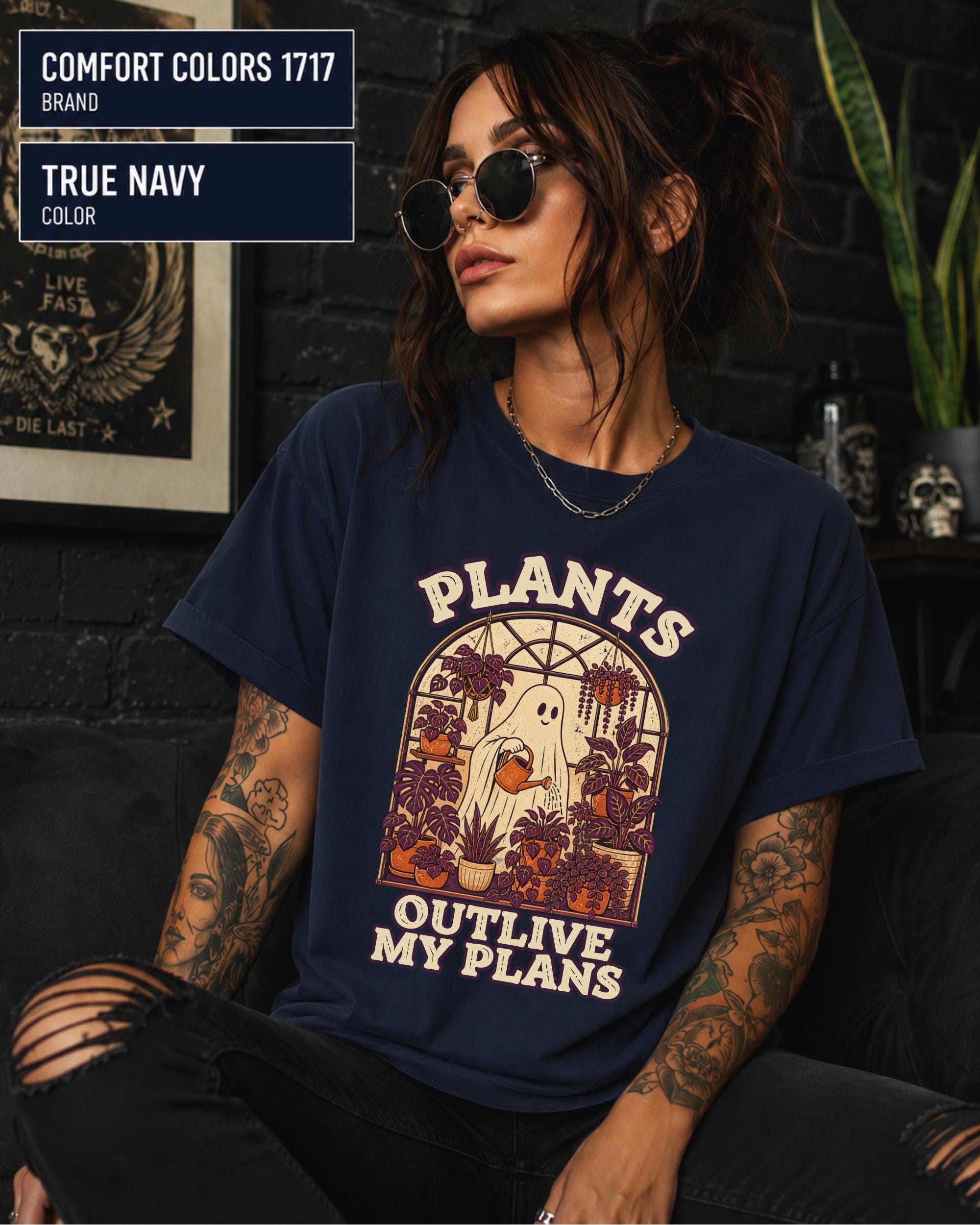 Model wearing Comfort colors tshirt in the color true navy featuring a Retro cream and orange ghost watering purple houseplants inside a greenhouse with the words Plants Outlive My Plans.